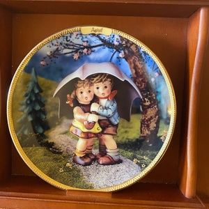 Hummel calendar plate set with wooden holder and calendar tiles.